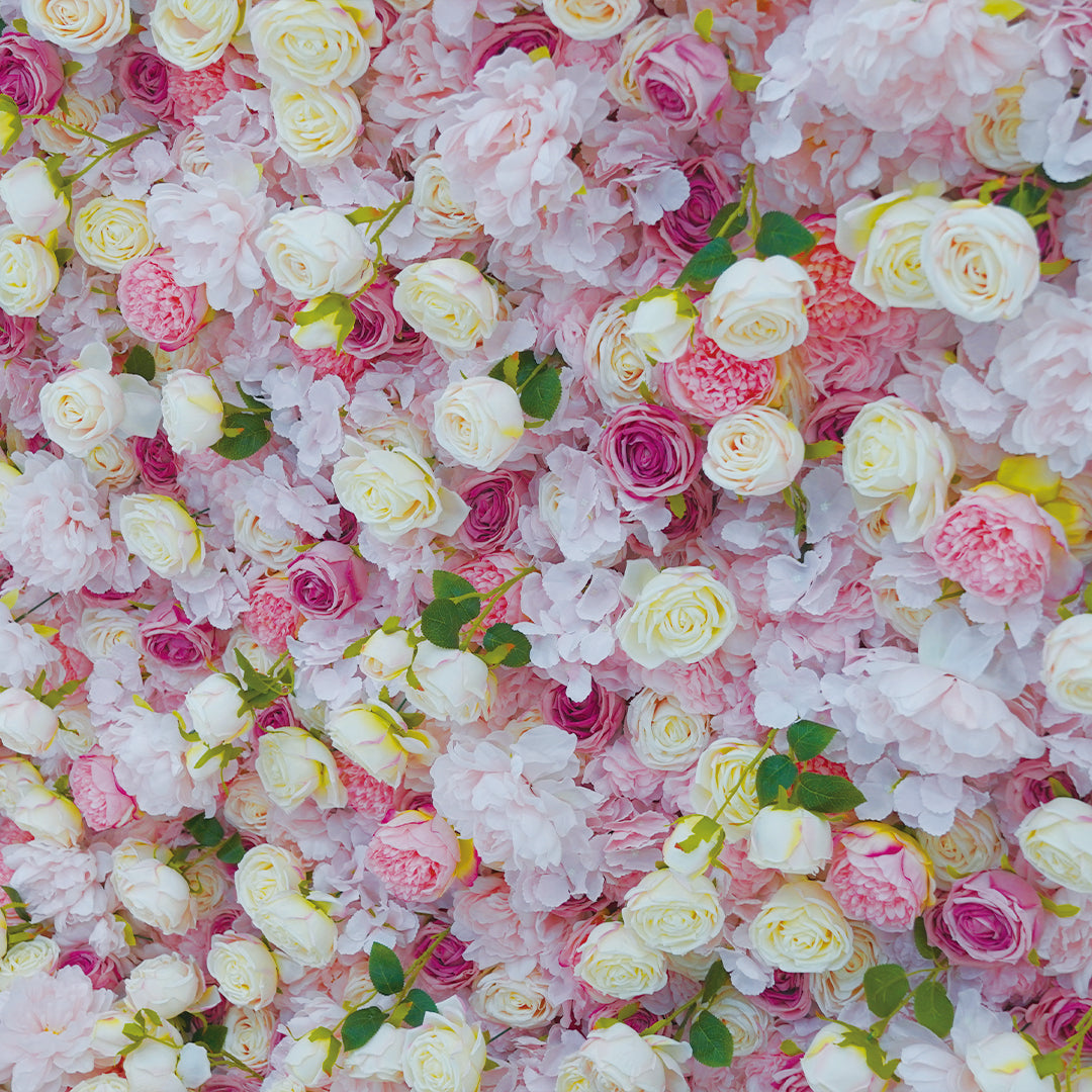 Wall of colorful flowers including pink, white, and purple roses.