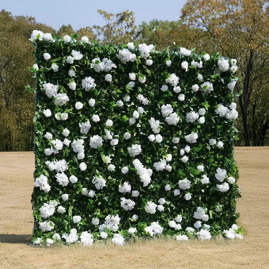 Artificial green wall with white flowers in an outdoor setting.