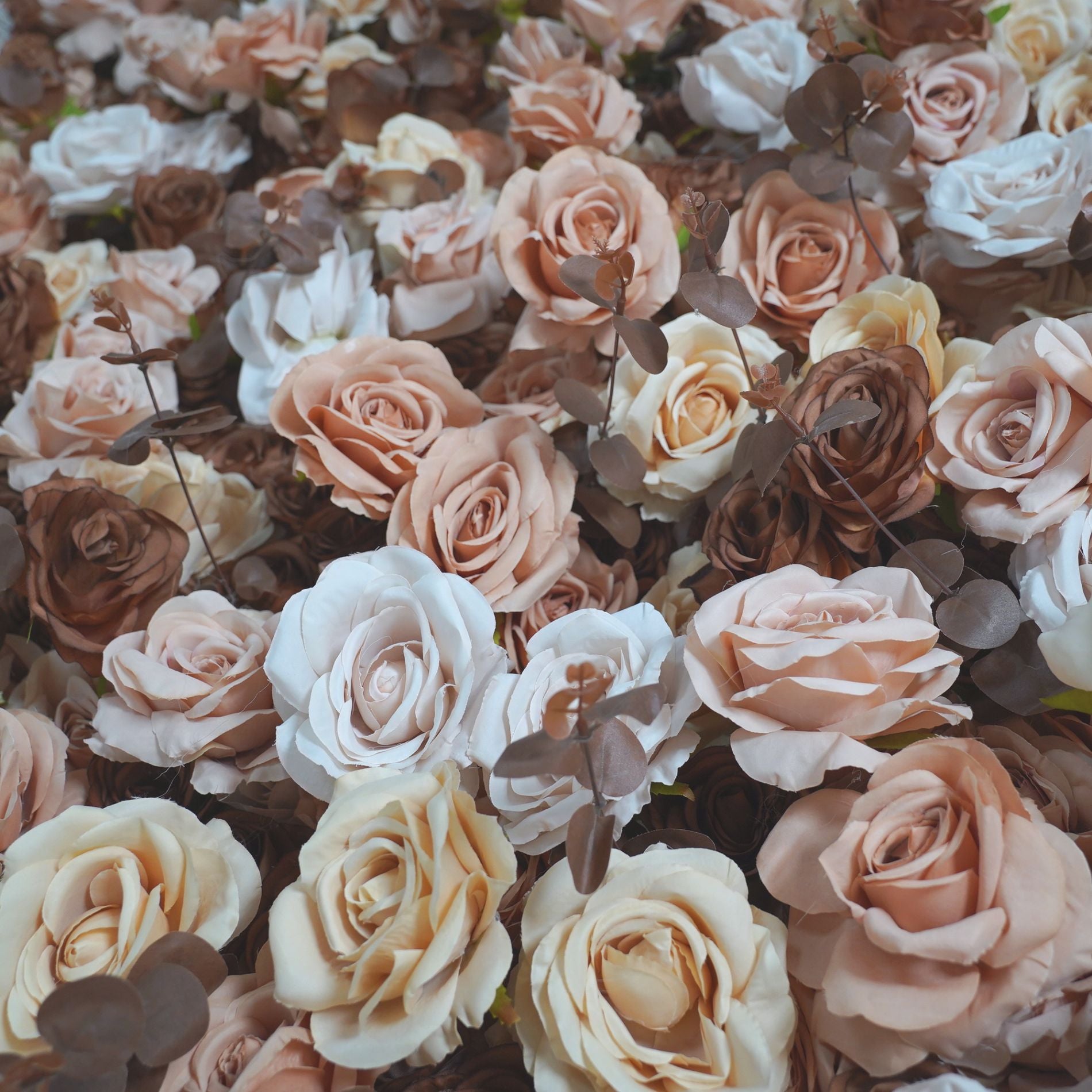 The coffee champagne flower wall backdrop looks romantic.