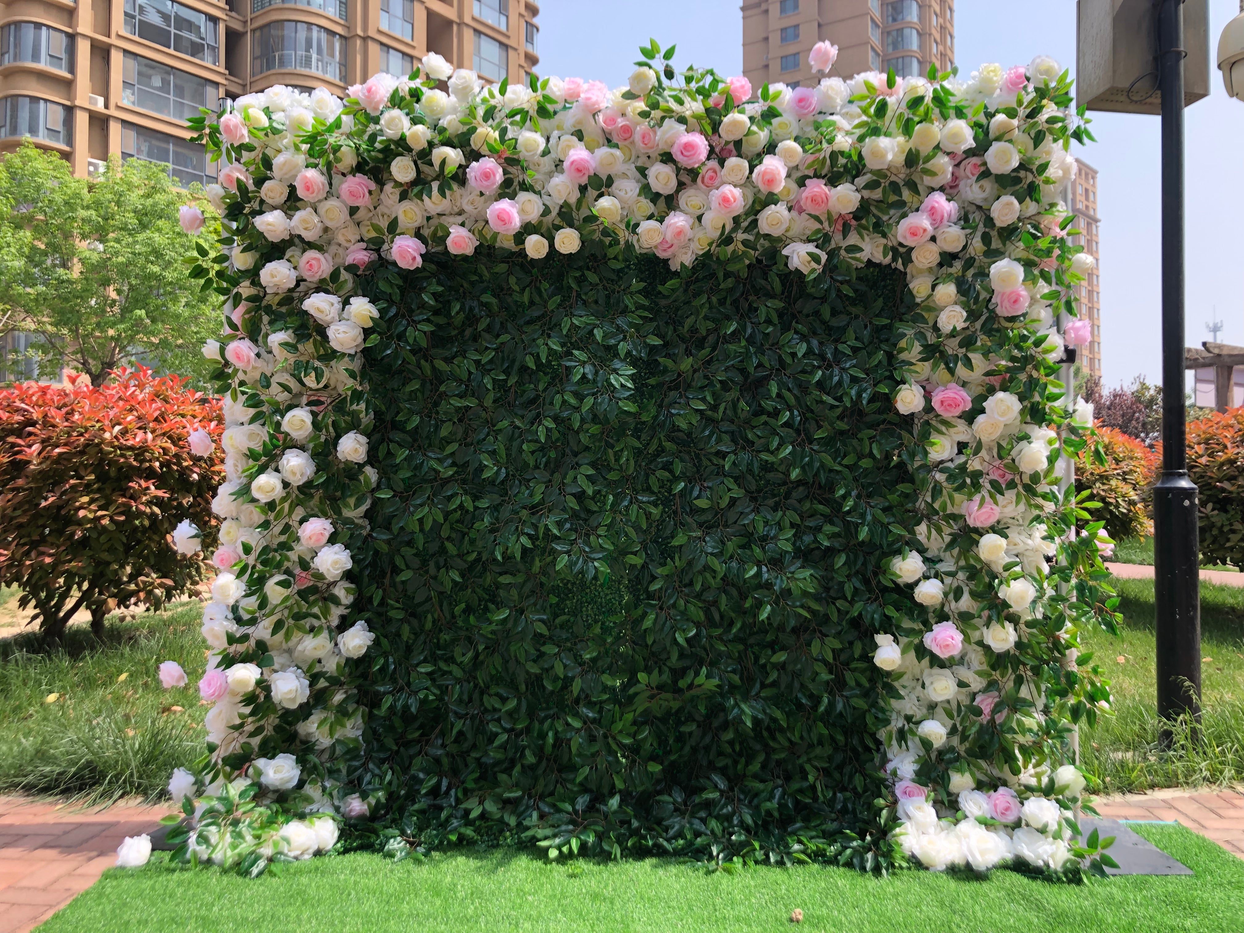 The pink white peony green leaves fabric flower wall looks full of life. 