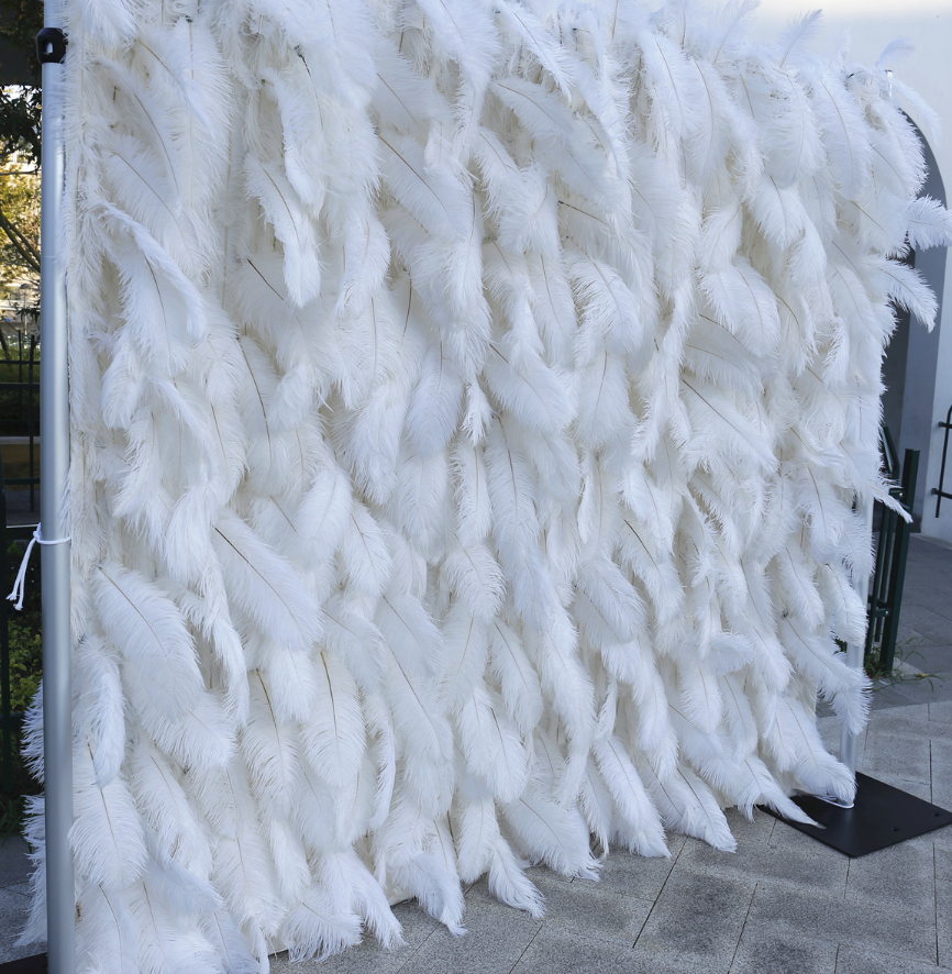 The white ostrich feather flower wall looks pure and elegant.
