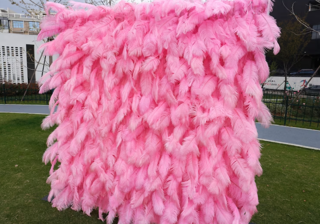 Pink ostrich feather fabric flower wall looks cute and innocent.