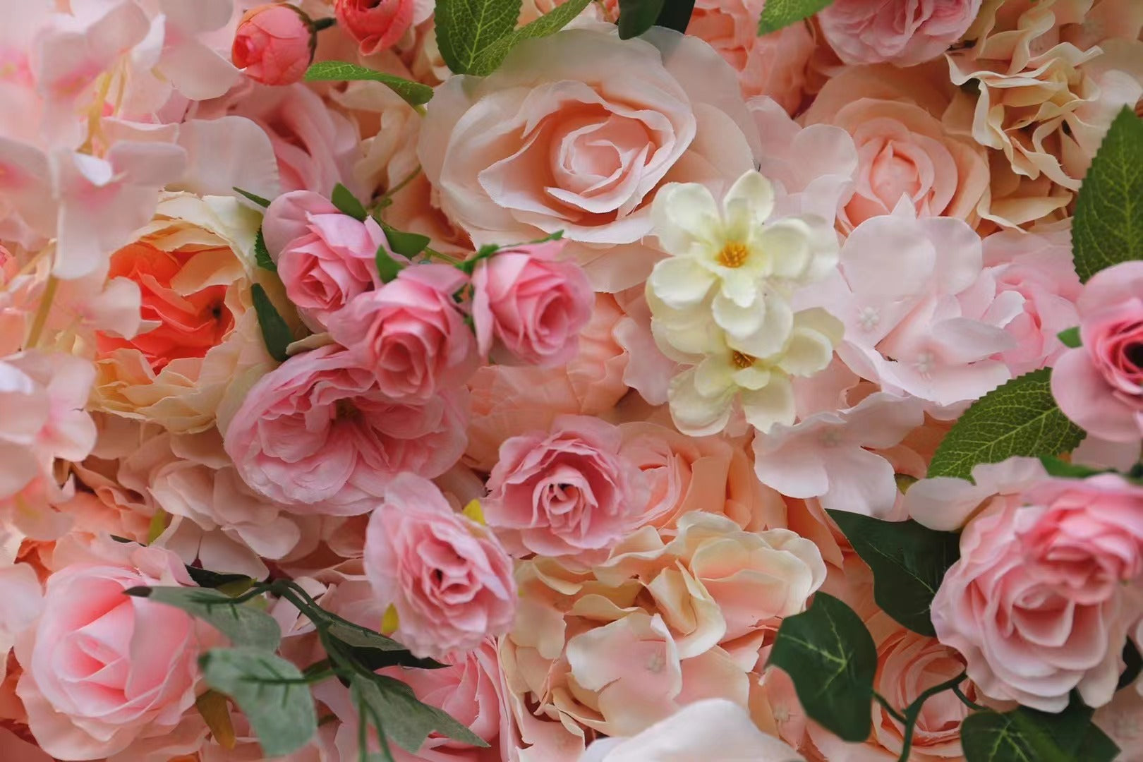The pink garden fabric flower wall looks sweet and romantic.