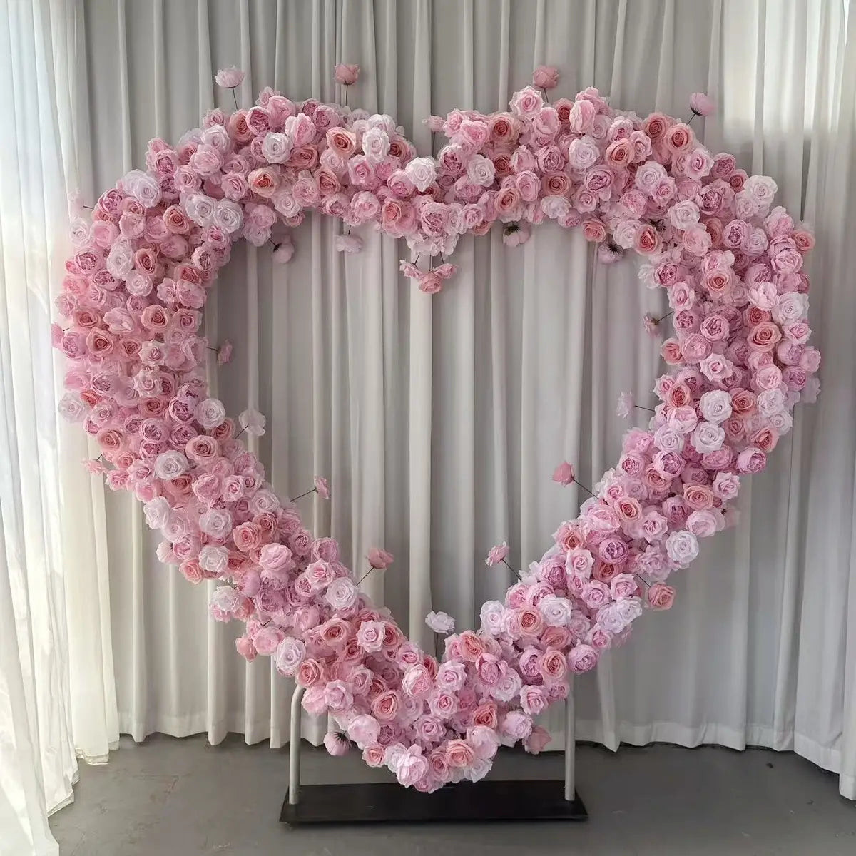 Pink heart shaped flower arch for wedding party.