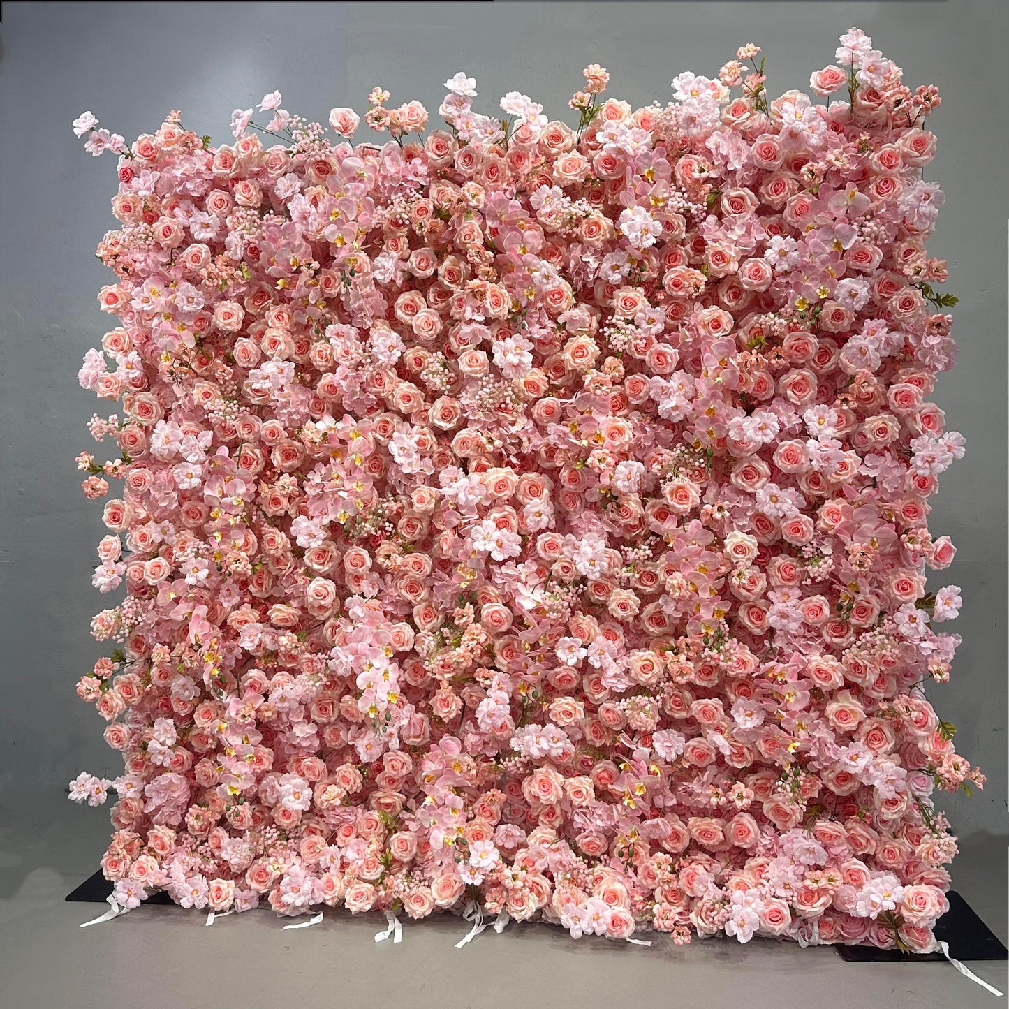 Pink floral wall backdrop on a gray background