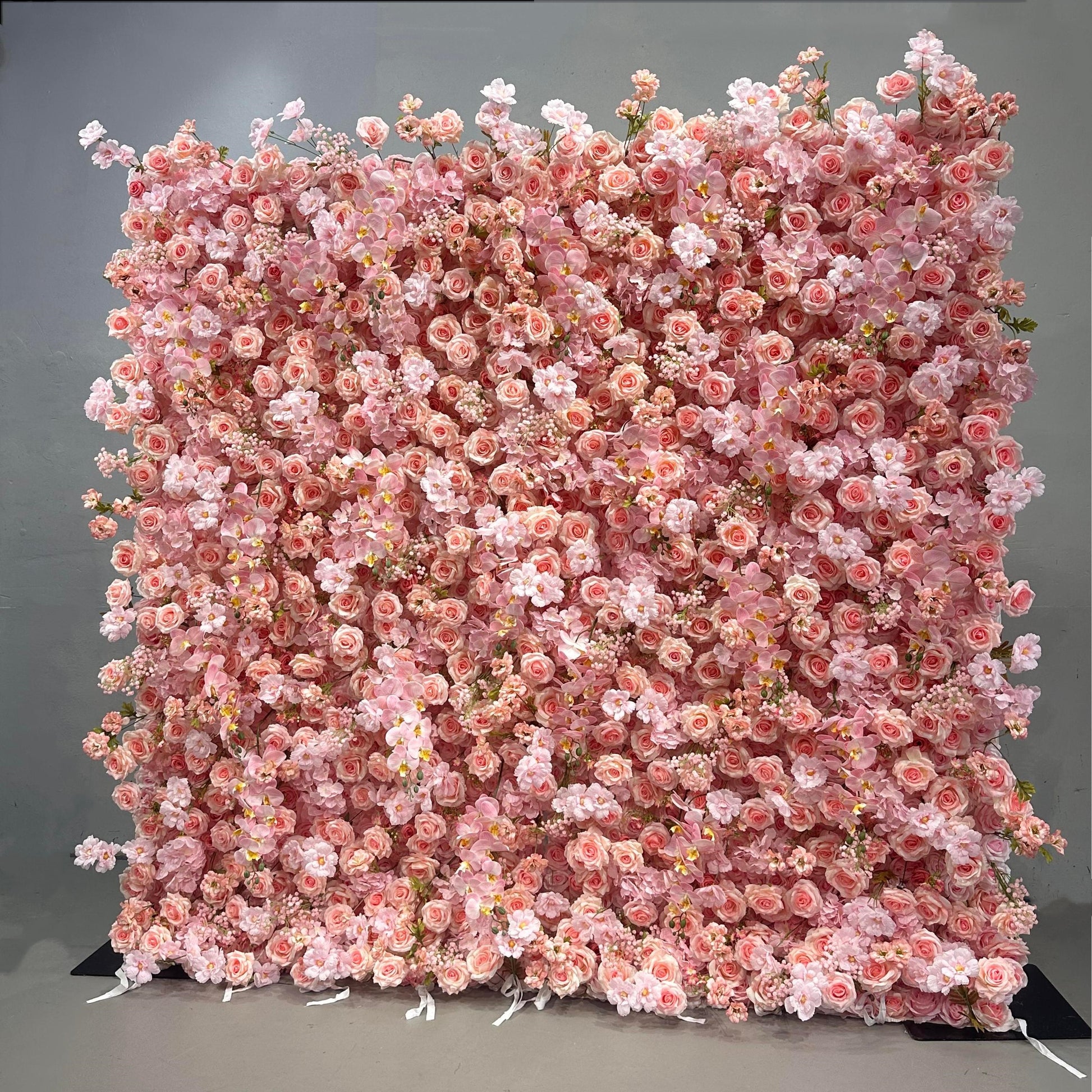 Pink floral wall backdrop on a gray background