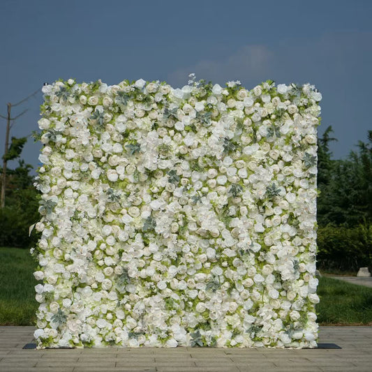 Floral wall with white flowers and greenery against a blue sky