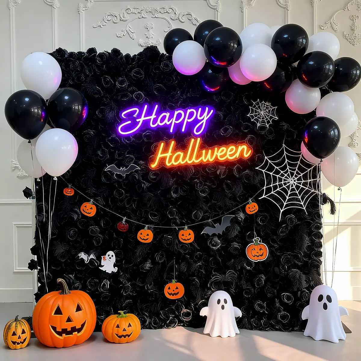 Halloween-themed backdrop with balloons, neon signs, and small decorations on a decorative wall.