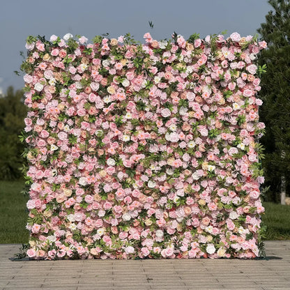 Floral wall with pink and white flowers on a wooden platform outdoors.
