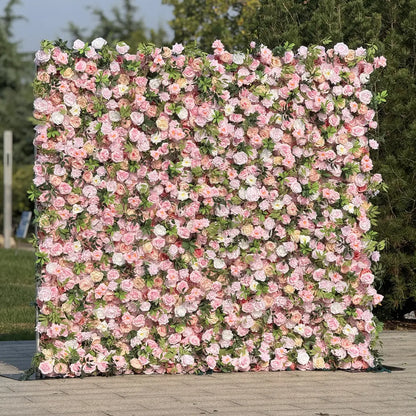 Floral wall with pink and white flowers on a wooden floor with greenery in the background