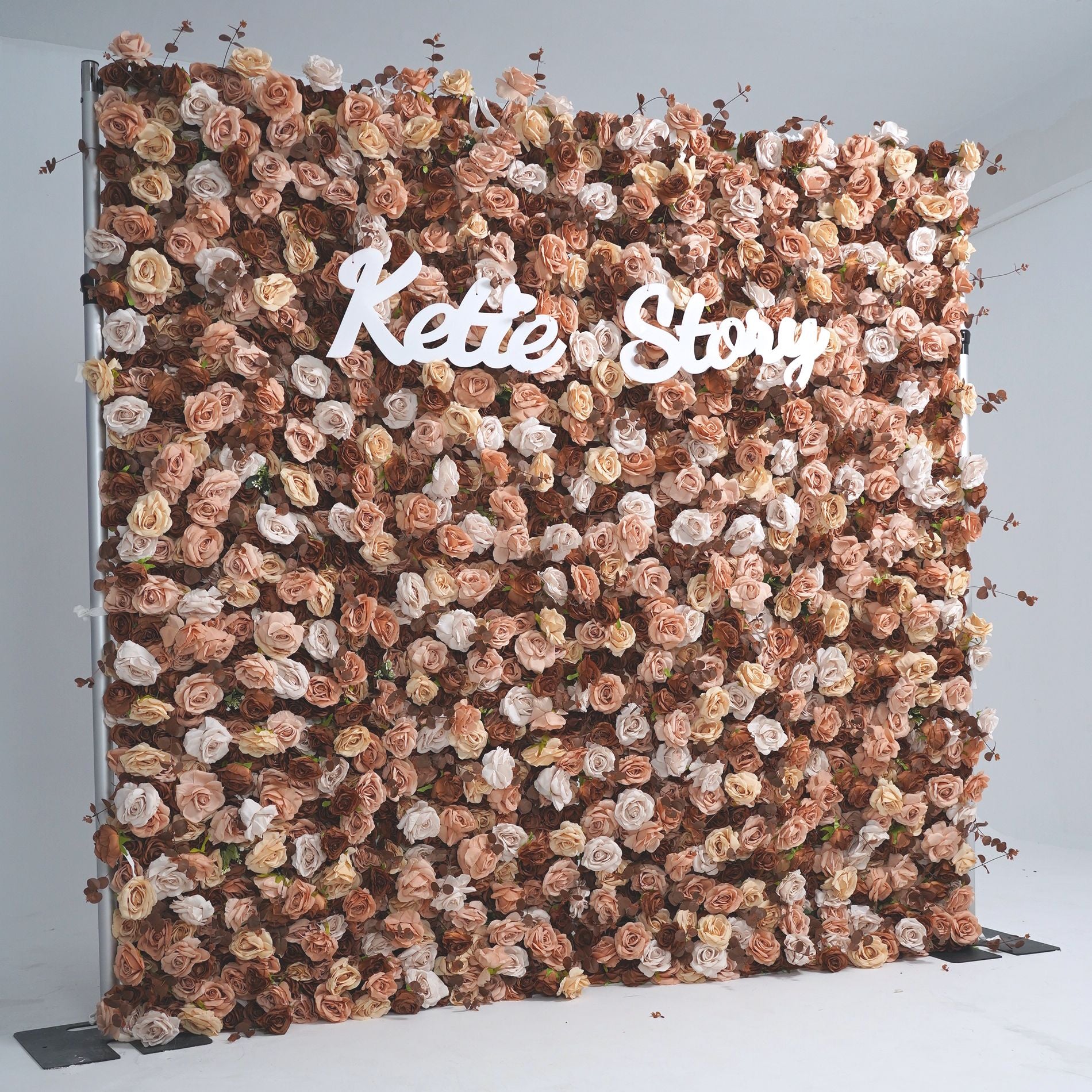 The coffee champagne flower wall backdrop looks romantic.