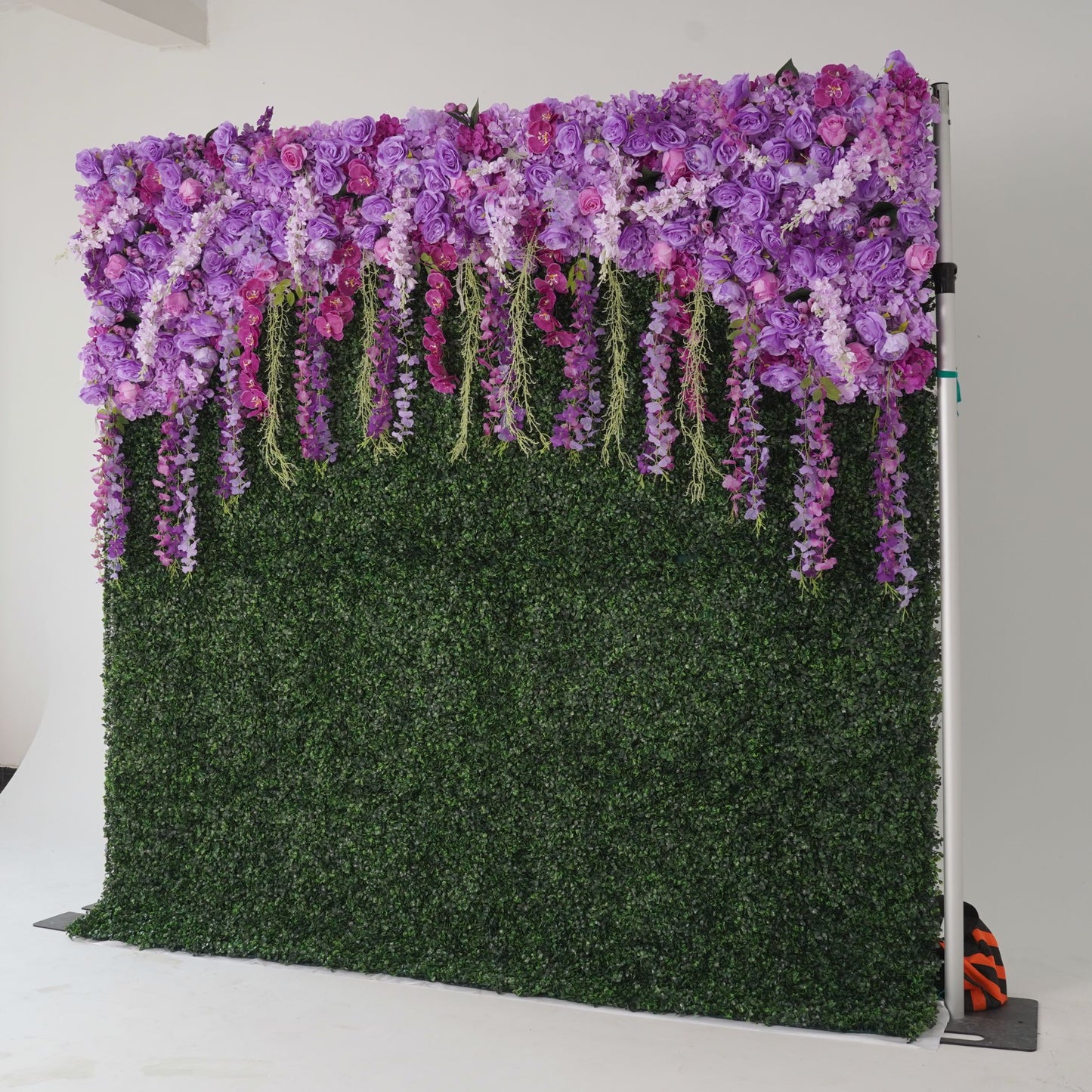 The purple flower wall's side view boasts realistic shapes and a fabric backing
