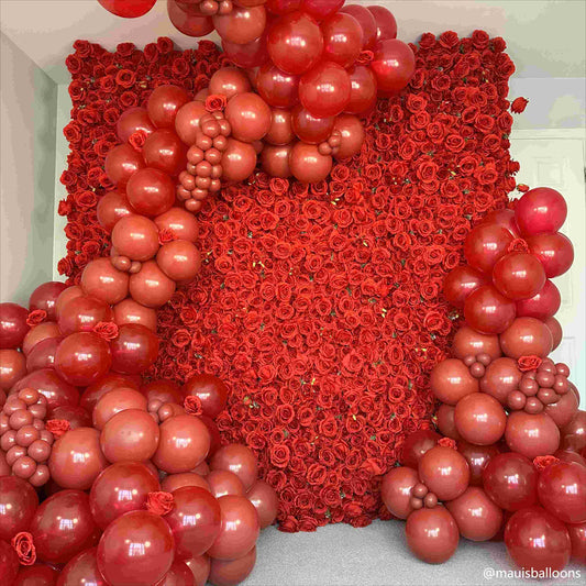 The bright red roses flower wall looks warm and romantic.
